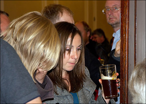 Girl tasting a bottled beer