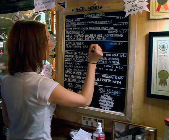Girl chalking in a new beer on the White Horse's beer menu