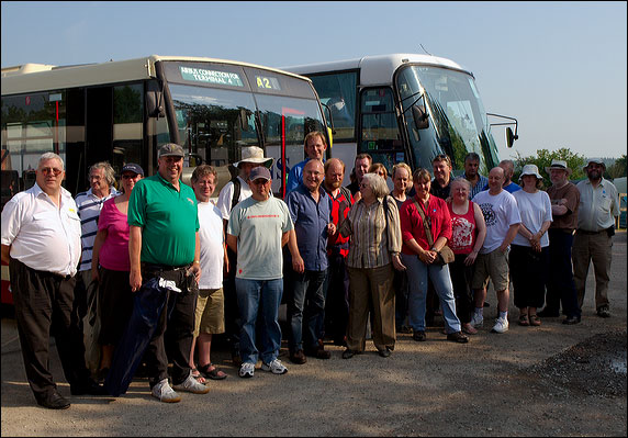 The party posing for a group photo outside the coach