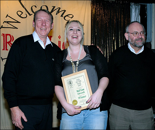 PotY presentation to Paul Andrews and Louisa on stage at the Red Lion