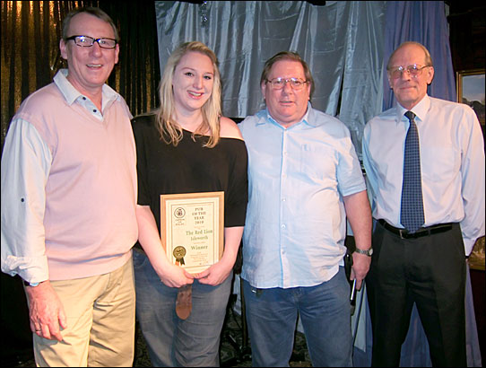 PotY 2010 presentation to Paul Andrews and Louisa on stage at the Red Lion